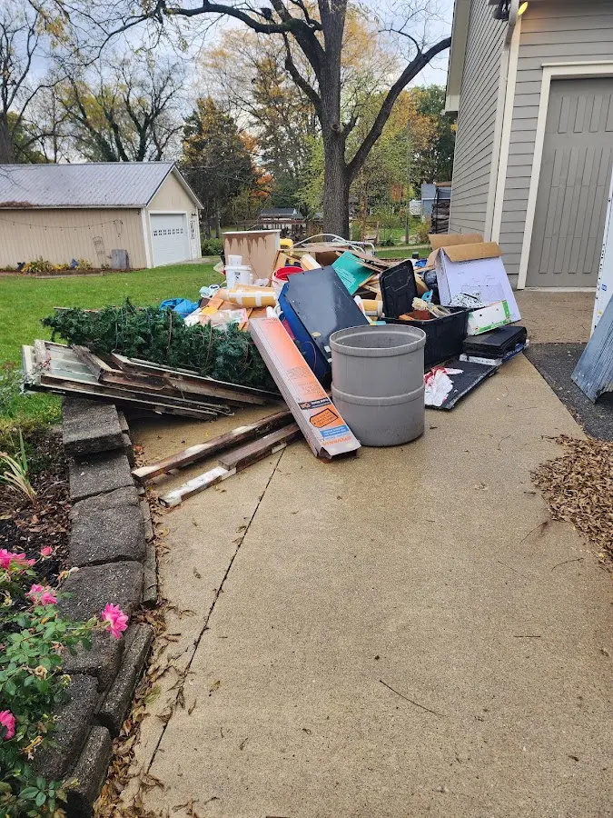 Dumpster being loaded with debris for Estate Cleanout Dumpster Rental in Medford